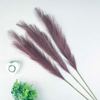 Scarlet Red Faux Pampas Grass Stem with a heart tealight holder and greenery, on a white background.