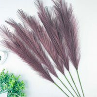 Scarlet Red Faux Pampas Grass Stems with a heart tealight holder and greenery, on a white background.