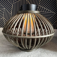 Bamboo Style Candle Lantern with candle lit, on a navy and gold background