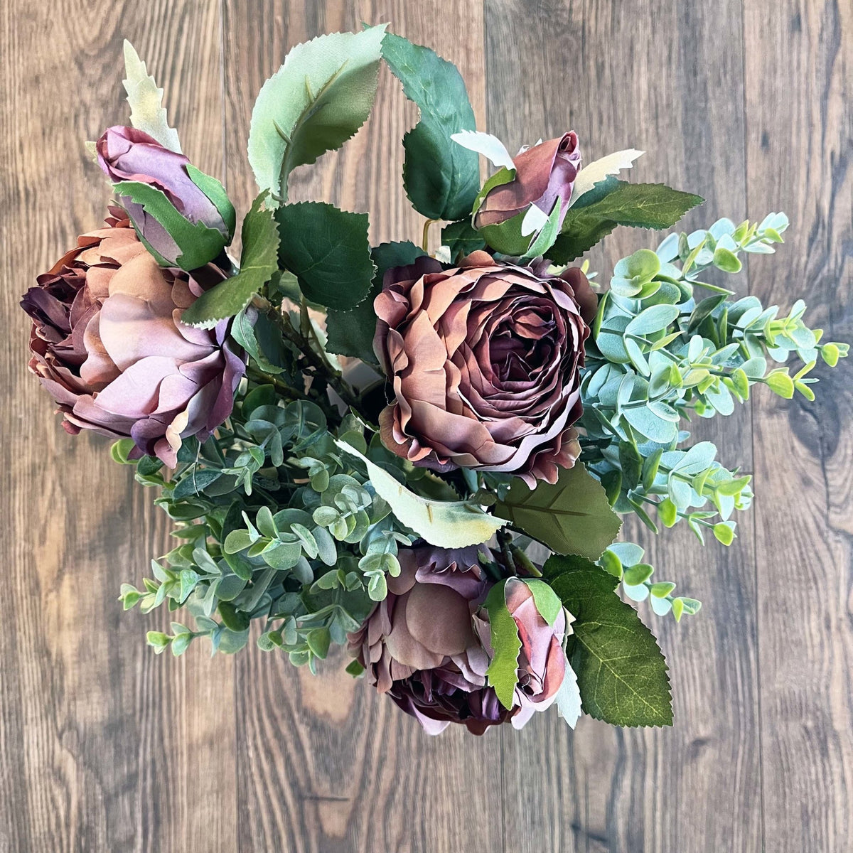 Dusty Pink Spray Rose Peony on a wood background.