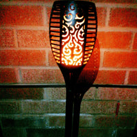 Flame Effect Solar Powered Garden Light lit up at night