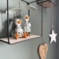 Happy Rainy Ducks ornament set on black shelving