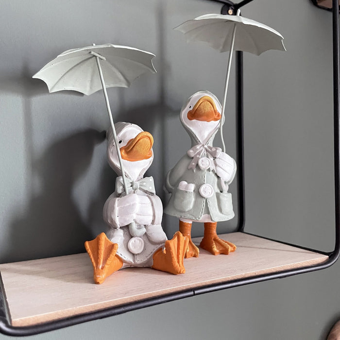 Happy Rainy Ducks ornament set of 2 on black wall shelf