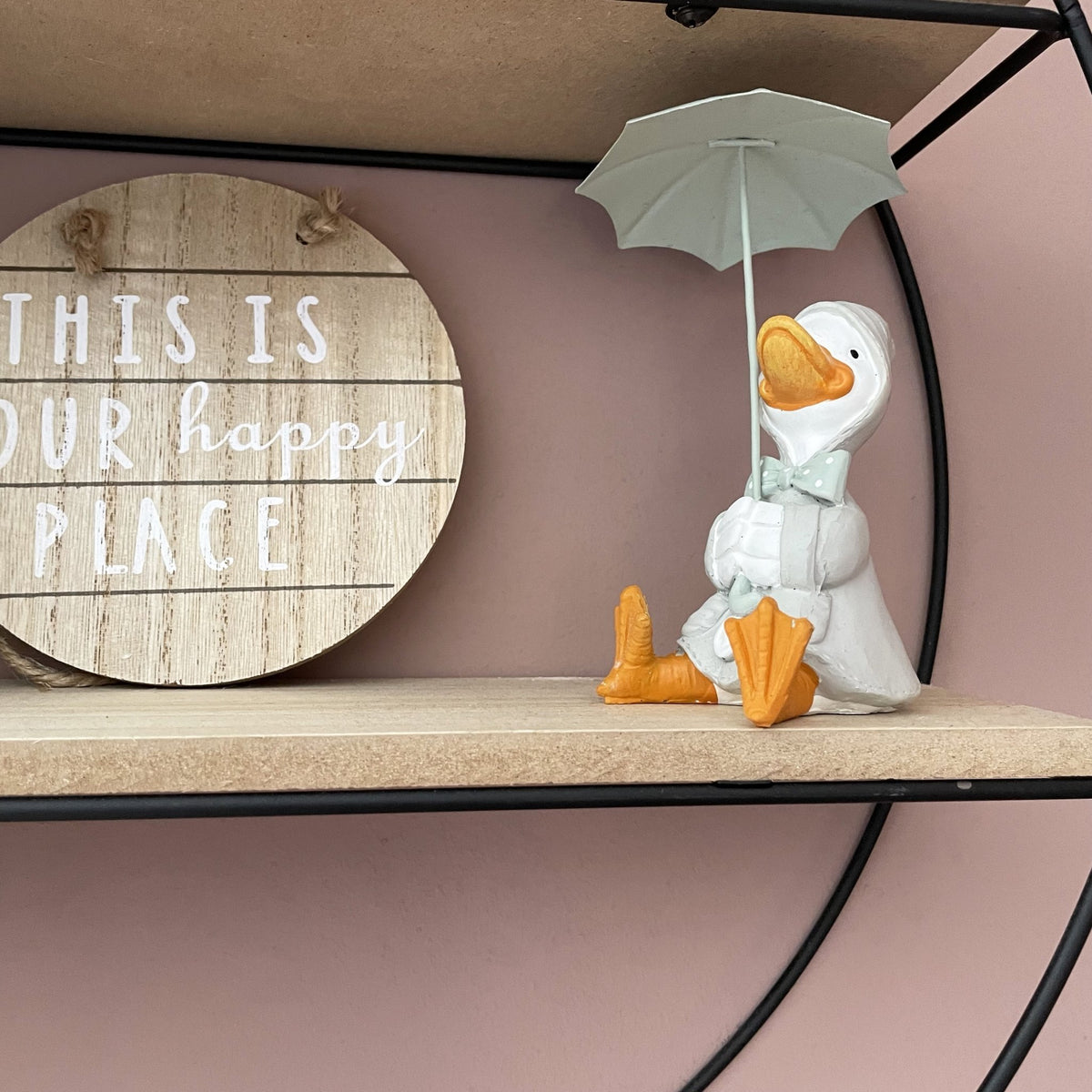 Happy Rainy Ducks ornament sat on shelving with wood sign saying this is our happy place.