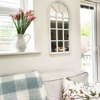 Velit Window Style Wall Mirror - White on white kitchen wall with pink flowers on the windowsill