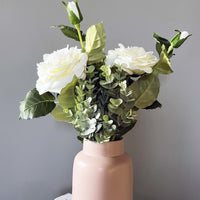 White Garden Rose Sprays in a blush pink vase on a grey background