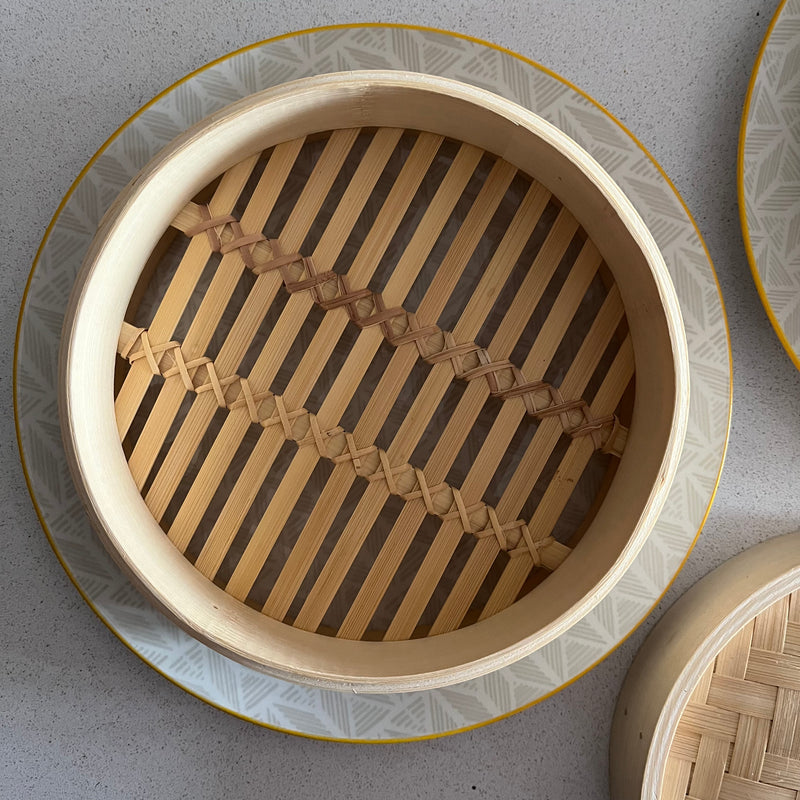 Two-Tier Bamboo Steamer on yellow and grey plate, top view