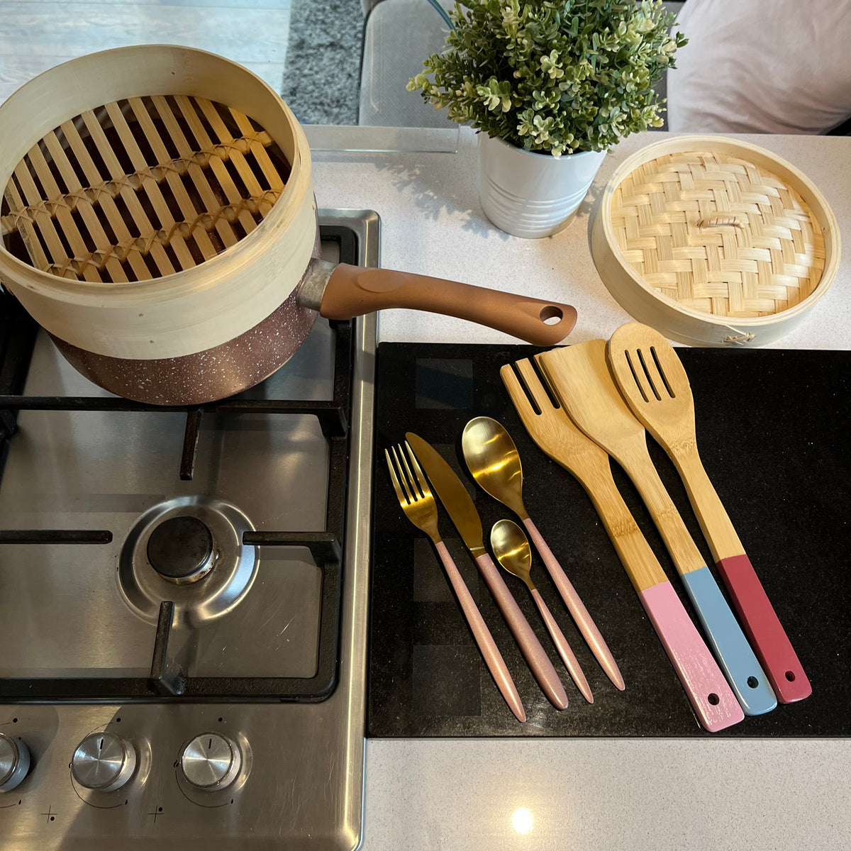 Two-Tier Bamboo Steamer on hob with utensils and cutlery