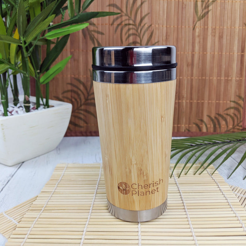 Bamboo portable mug with plant in white planter.