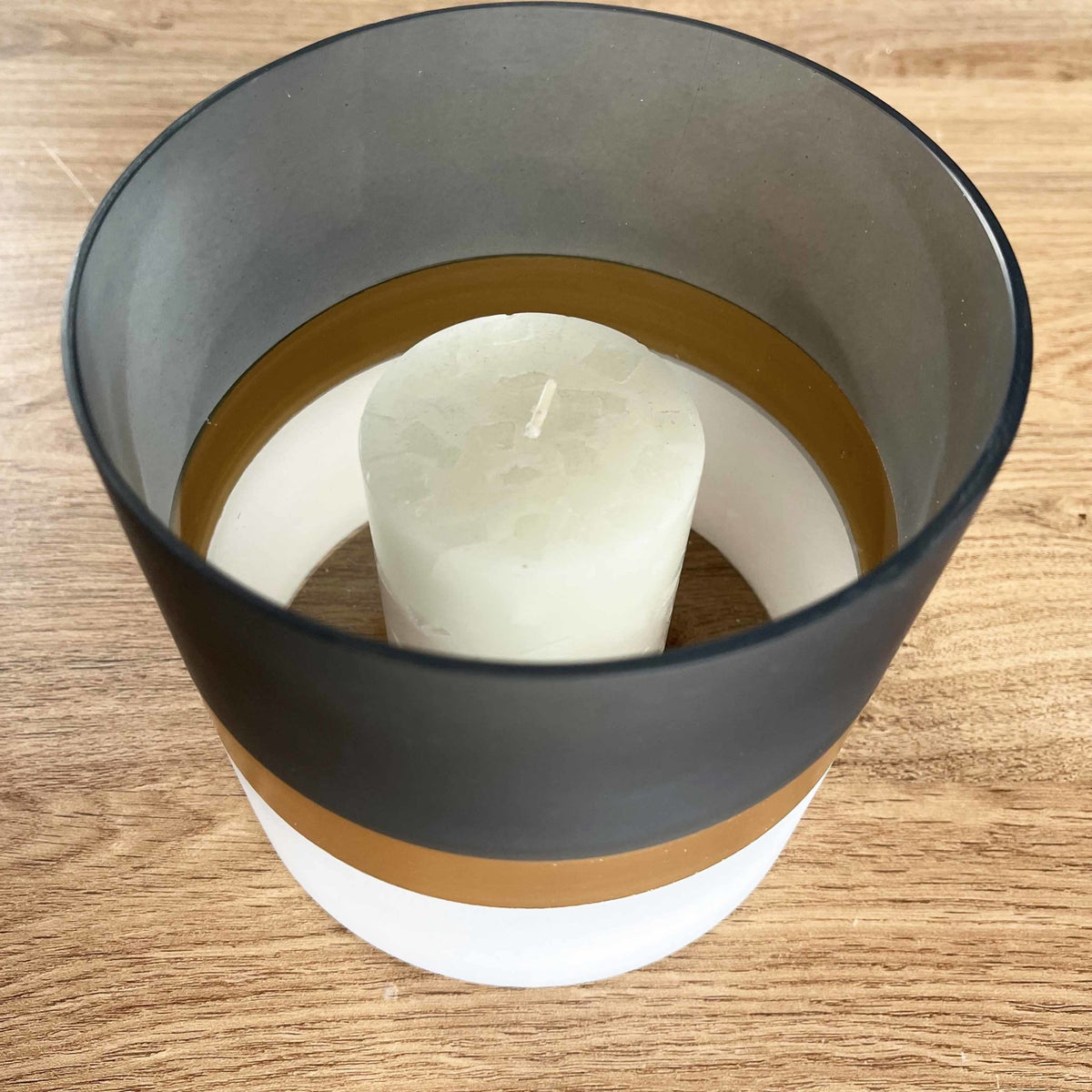 Contra Frosted Glass Votive Candle Holder on wooden table, candle in votive