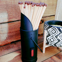 Cute Metal Match Stick Holder in black, on wood bench seat with black and white citronella candle