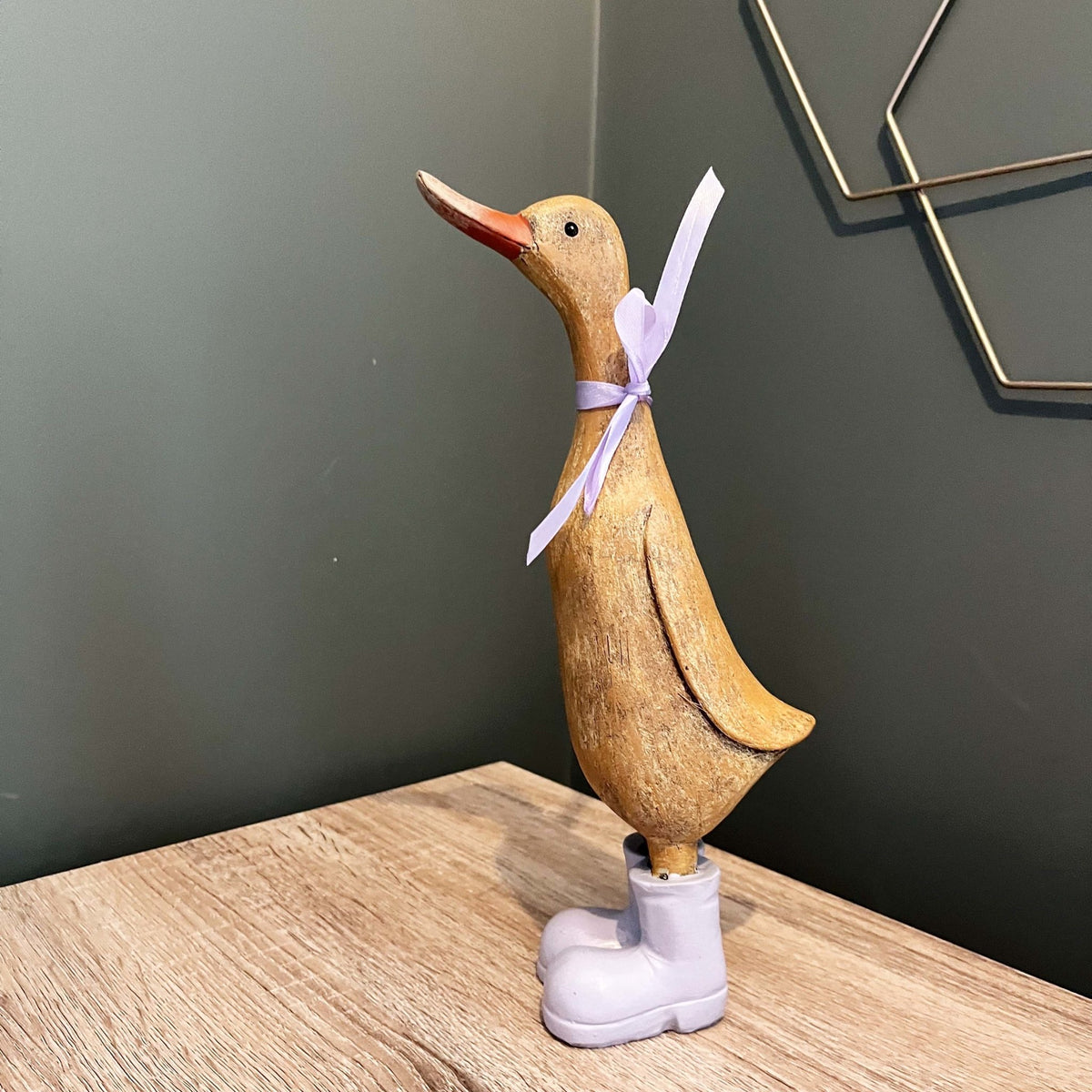 Darcey Duck on a an office desk, with memo holder on green wall