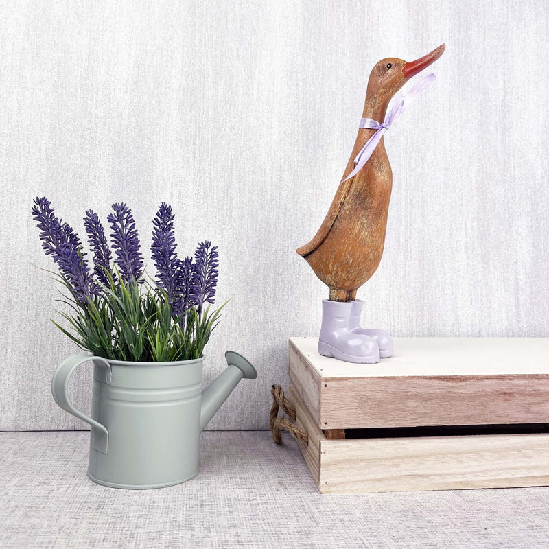 Darcey Duck on crate with watering can planter holding lavender stems