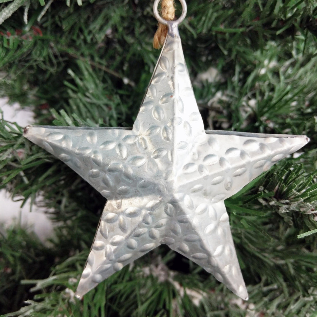 Decorative Metal Hanging Star on Christmas Tree close up