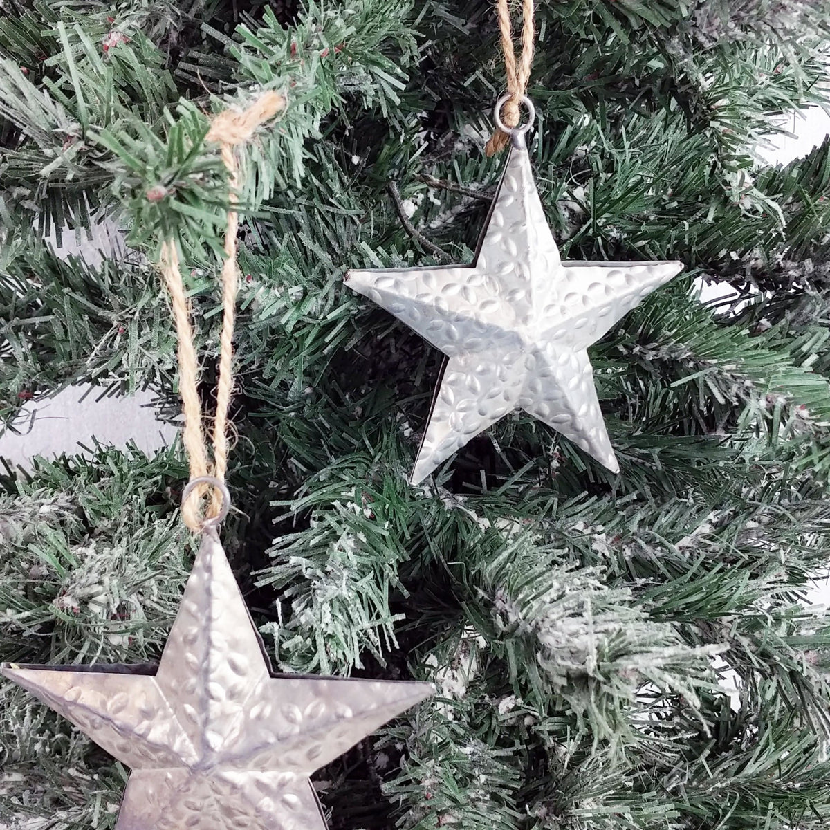 Decorative Metal Hanging Star on Christmas Tree close up