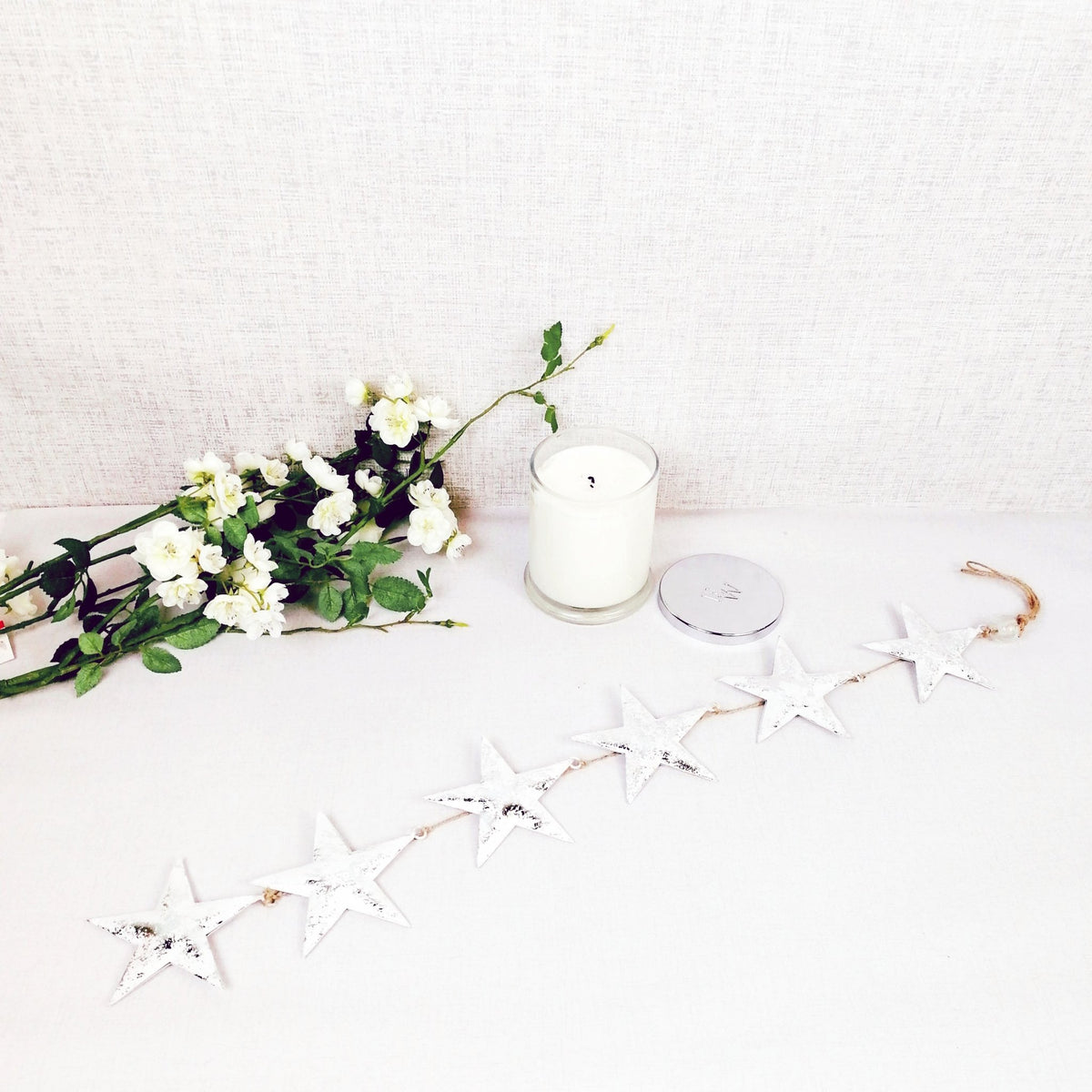 Decorative white hanging stars with christmas candle
