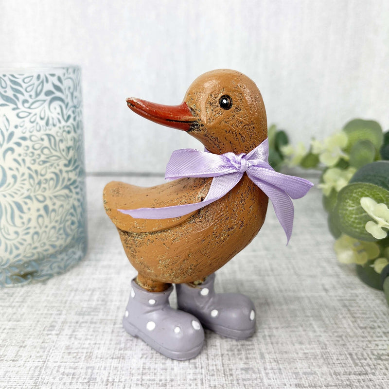 Dina Duck close up with candle and floral stem