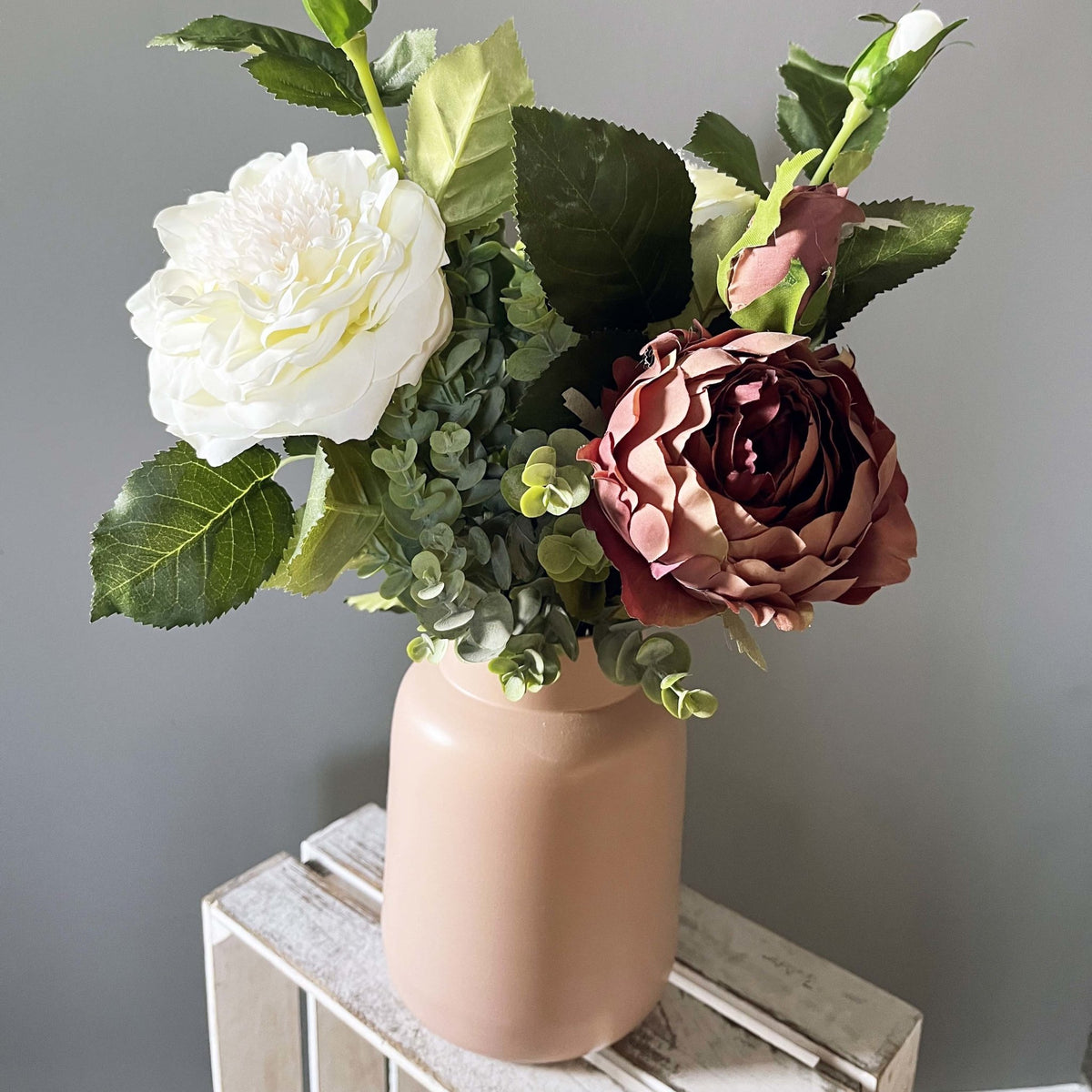 Dusty Pink Spray Rose Peony with leafy spray and white garden rose in pink vase.