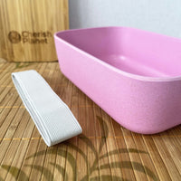 Pink Eco Bamboo & Wheat Fibre Lunch / Bento Box on bamboo mat, close up
