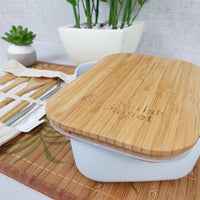 White Eco Bamboo & Wheat Fibre Lunch / Bento Box and cutlery set on white background, and green plant