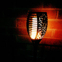 Flame Effect Solar Powered Garden Light lit up at night