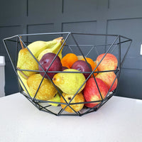 Geometric Contemporary Wire Storage Basket Fruit Bowl with fruit in on black background