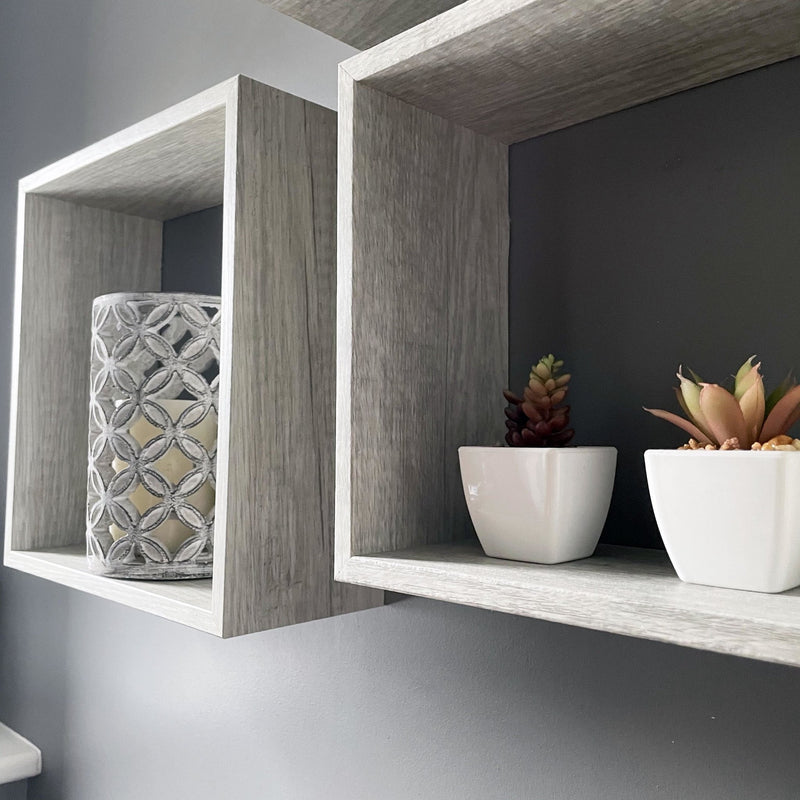 Geometric Stone Candle Holder on shelf with white planters