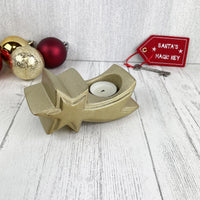 Gold star tea light candle holder with baubles and santa's magic key