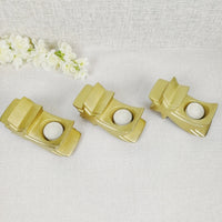 Set of three gold star tea light candle holders top