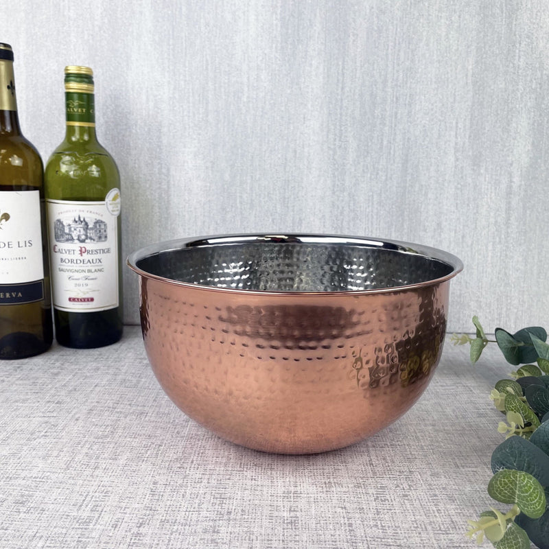 Large Hammered Copper-style Bowl with some wine in the background