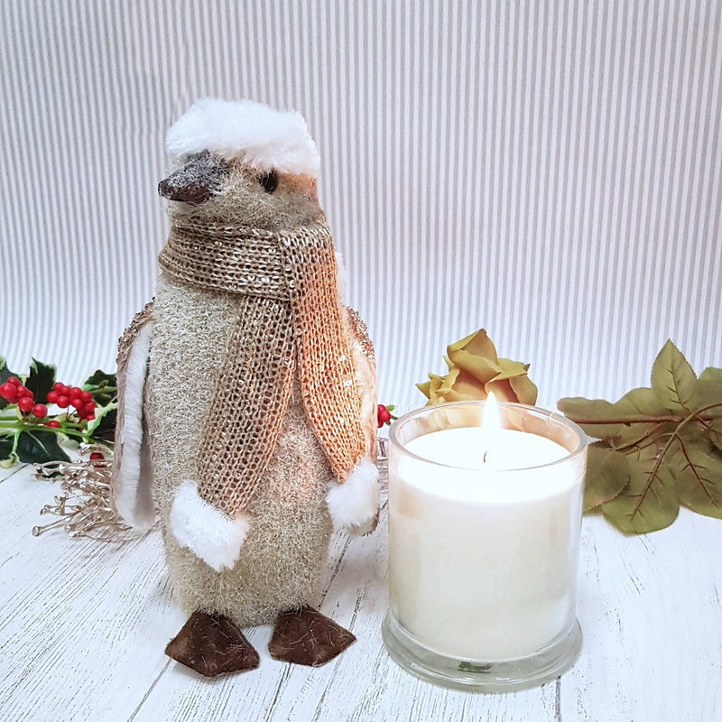 Winter Jasmine and Vanilla Christmas Candle with fluffy penguin close up