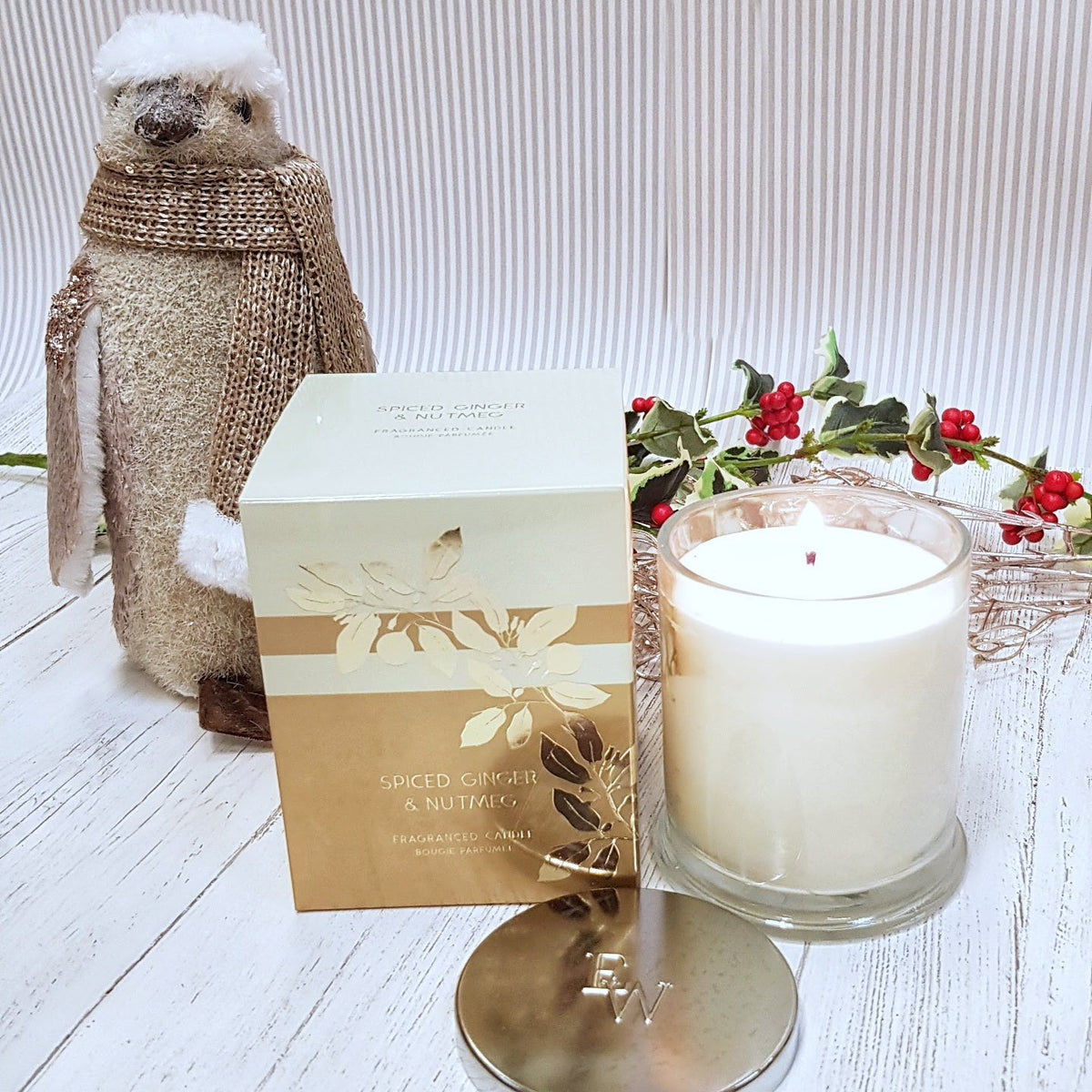 Spiced Ginger & Nutmeg Scented Candle close up with Penguin ornament