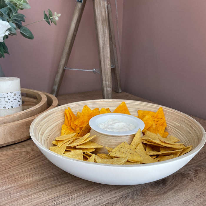 Pandam Bambo Chip 'n' Dip Bowl filled with crisps, on a table with a candle and some wooden trays