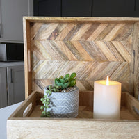Rectangular Herringbone Wooden Serving Trays with planter and lit candle on black background
