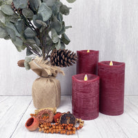 Red Luminara Flame Effect Battery candle set with a Eucalyptus plant and autumn decor