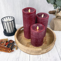 Red Luminara Flame Effect Battery candle set of 3 on a decorative herringbone tray and with autumn details