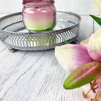 Regiis Silver Style Mirror Tray with pink candle and flowers, close up