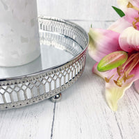 Regiis Silver Style Mirror Tray close up with grey candle and pink flowers