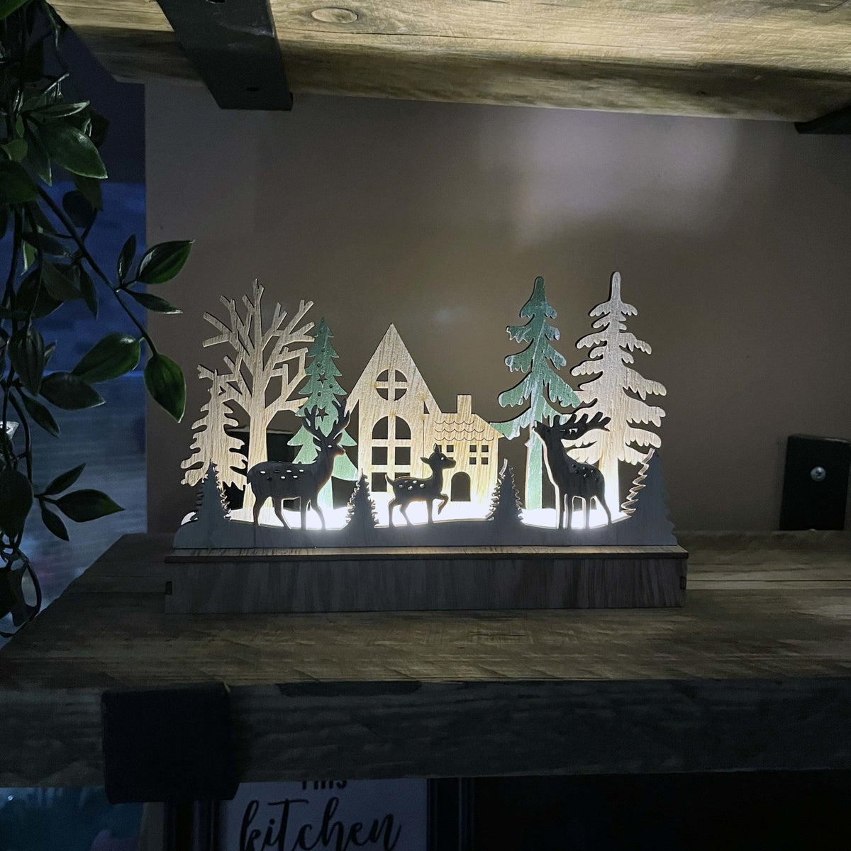 Reindeer & Trees LED Scene Decoration lit up on kitchen shelves