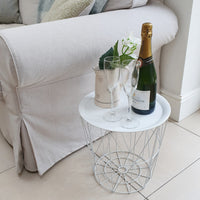 White metal tray table geometric with champagne and vase