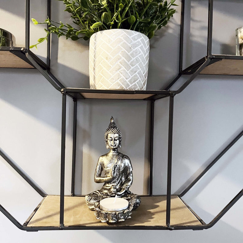 Silver Effect Buddha Candle Holder on shelving with grey planter