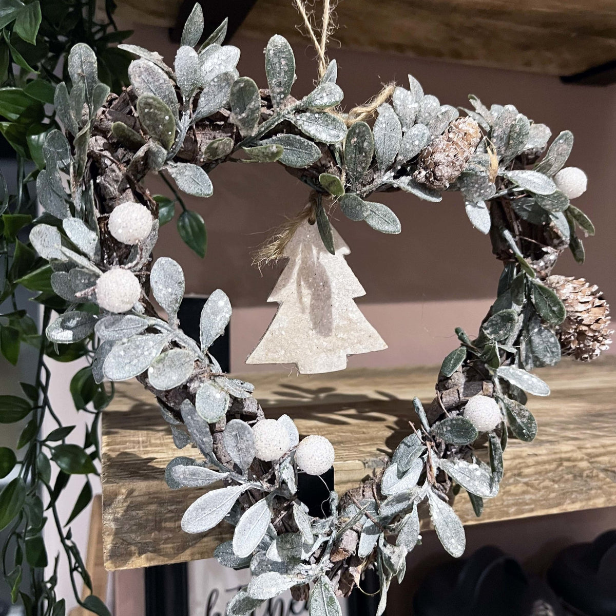 Small Heart-shaped Christmas Tree Wreath hung on wooden shelf