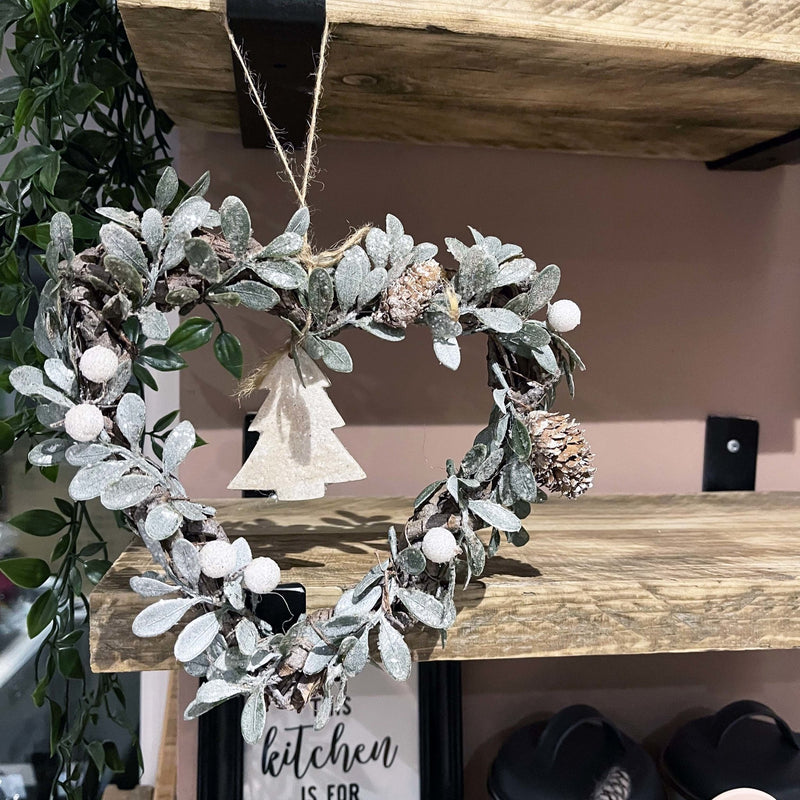 Small Heart-shaped Christmas Tree Wreath hung on a wooden shelf
