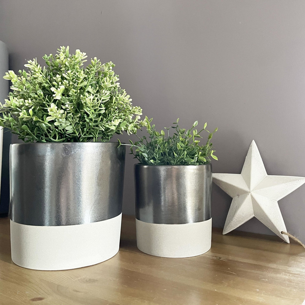 Terra Grey Metallic Style Planters with greenery on table with white star decor