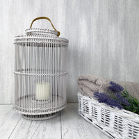 Grey Usiku Bamboo Lantern with white basket filled with lavender and cosy throws
