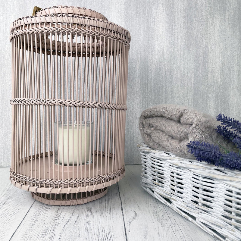 Usiku Bamboo Lantern in blush pink, with a white baskets filled with lavender and cosy throws